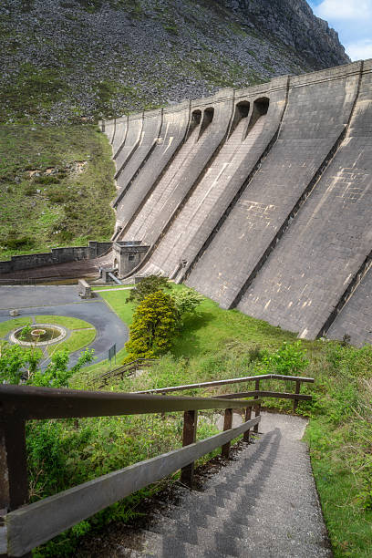istock Experience the stunning panoramic view of a modern dam, surrounded by lush greenery and vibrant landscapes 2210831131