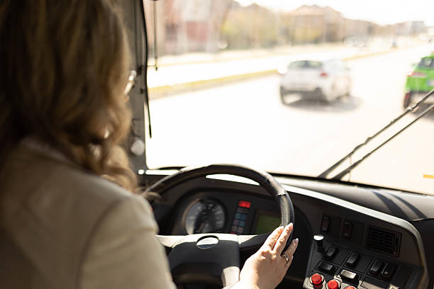 istock Female bus driver driving a city bus. 2210831670