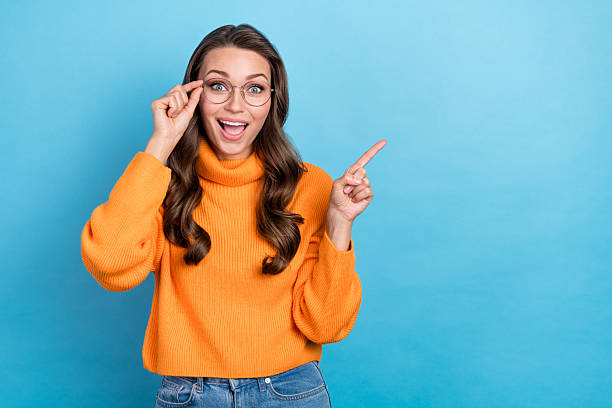 istock Photo of shiny dreamy lady dressed orange pullover arm eyewear looking emtpy space isolated blue color background 2210832329
