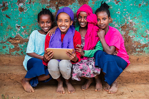 istock African young girls using digital tablet, East Africa 2210834856