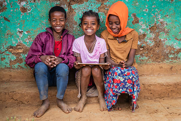 istock African children using digital tablet, East Africa 2210835022