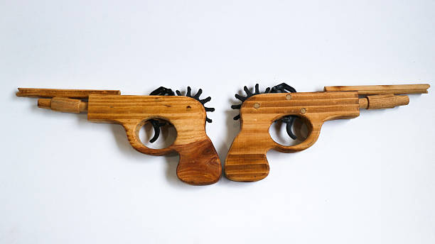 say no to school violence - a gun surrounded by yellow pencils