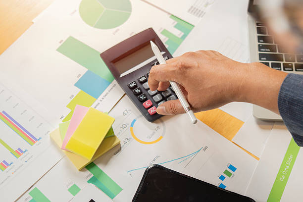 istock Businessmen or Accountants using calculator and a laptop computer to analyze business report graphs 2210840155