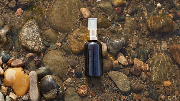 istock Black spray bottle on riverbed stones 2210843458