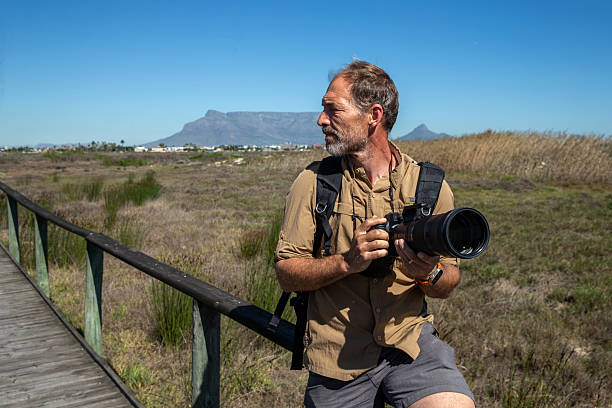 istock Photographer scouting for birds in the Nature reserve 2210844245