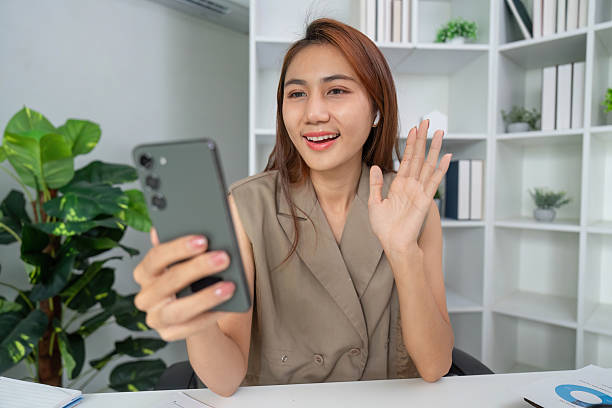 istock Communication and Connection. A cheerful woman engaging in a video call, feeling connected with her virtual audience. 2210850726