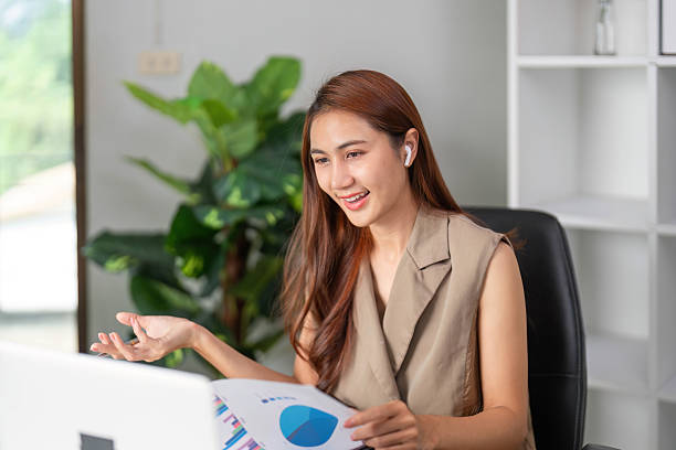 istock Effective Communication and Presentation Skills. A woman using earphones while presenting business data online. 2210851285