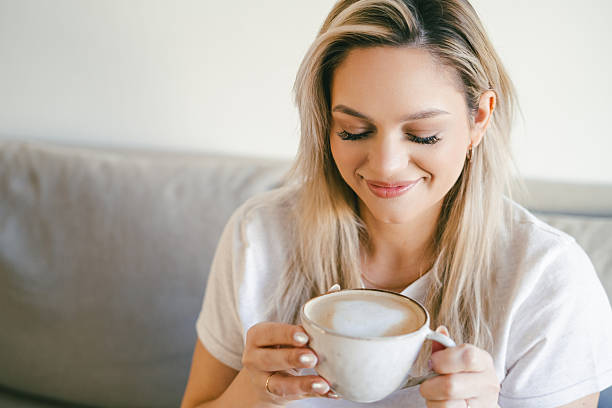 istock Young beautiful woman drinking hot cappuccino. 2210853096