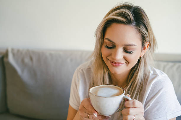 istock Young beautiful woman drinking hot cappuccino. 2210853181