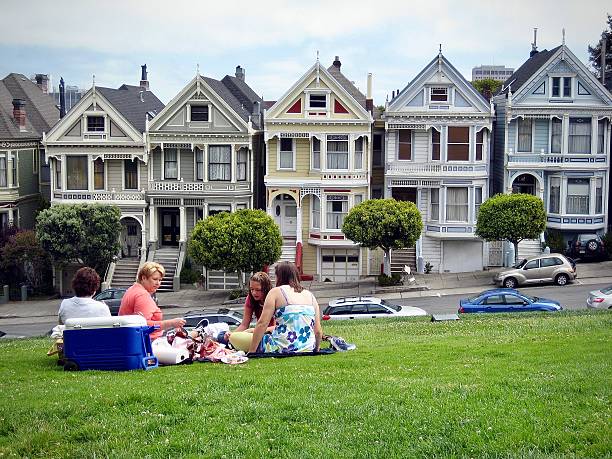 Tourists in Alamo Square with Painted Ladies in background, San Francisco