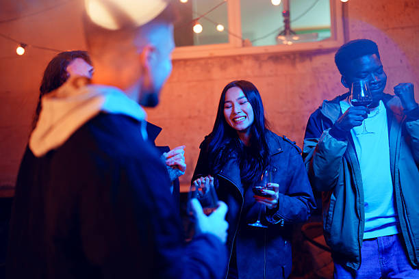 istock Friends enjoy an evening gathering with drinks while celebrating under string lights in an outdoor setting 2210855861