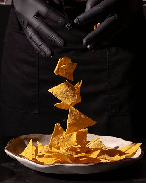 Creative culinary action floating tortilla chips in a modern kitchen food photography indoor setting unique perspective snack inspiration