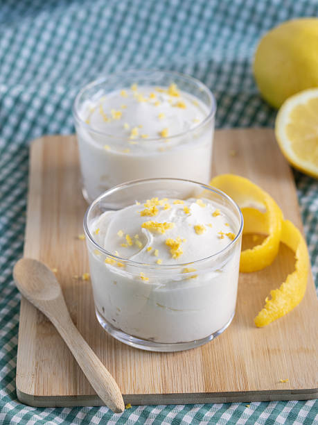 istock Creamy lemon mousse served in small dessert glasses. Natural light. 2210858425