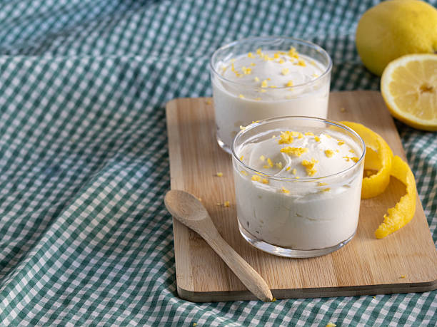 istock Creamy lemon mousse served in small dessert glasses. Natural light. 2210858436