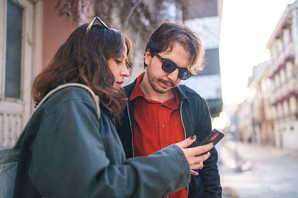 istock Young Couple Using Mobile in City Street. 2210859646