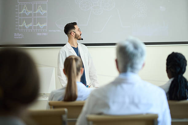 istock Scientist Leading Medical Presentation to Colleagues 2210865028