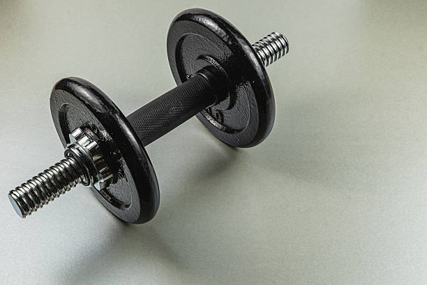 istock Black dumbbell on a gray surface for fitness training 2210866008