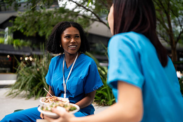 istock Nurses Bonding Over Lunch Outdoors in Sydney 2210868119
