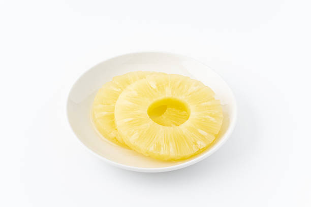 istock Sliced pineapple in syrup on a plate 2210873189