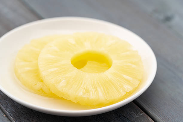 istock Sliced pineapple in syrup on a plate 2210873385