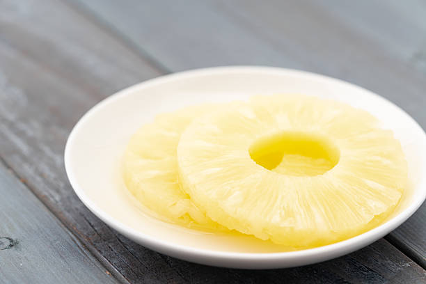 istock Sliced pineapple in syrup on a plate 2210873404