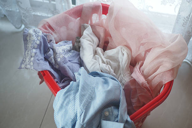 istock Colorful laundry in a red basket by a window brightens the space 2210874284