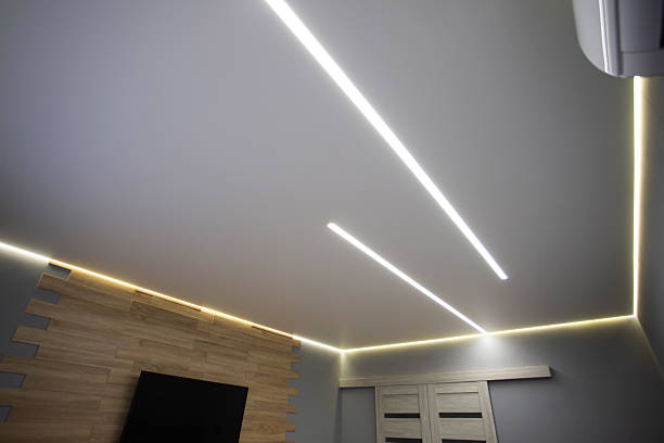 istock Beautiful modern stretch ceiling with yellow LED lines around the perimeter. Designer stylish ceiling in the hall. 2210876431