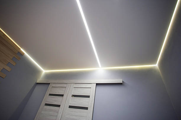 istock Beautiful modern stretch ceiling with yellow LED lines around the perimeter. Designer stylish ceiling in the hall. 2210876443