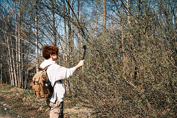 Female backpacker is filming swamp landscape in early spring