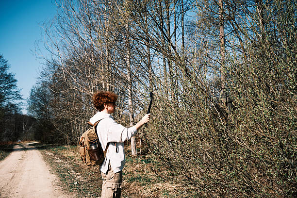 Female backpacker is filming swamp landscape in early spring