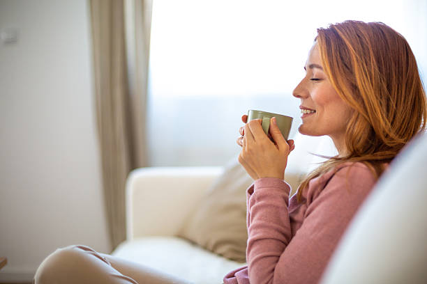 istock Relaxed woman enjoying a hot beverage at home 2210881084