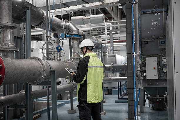 istock Asian Engineer Performing Pipe System Inspection in Modern Industrial Facility 2210881581