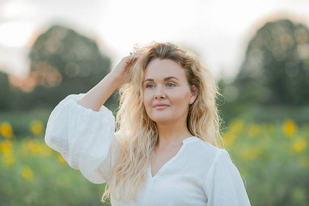 istock Young beautiful woman in wheat field in summer. 2210883270