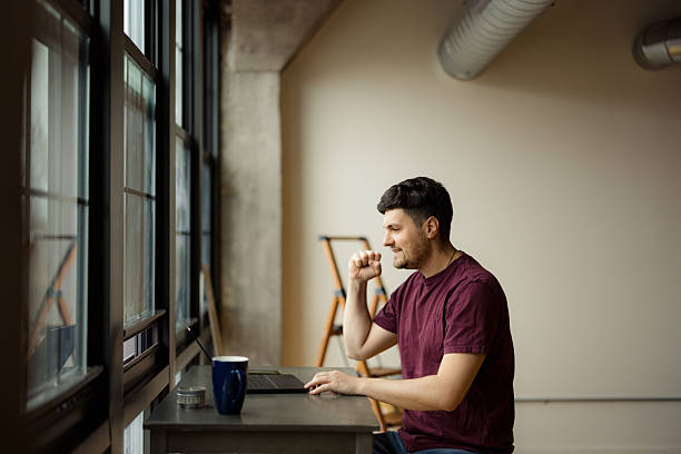istock Man Working on a Laptop in a Modern Stylish Workspace 2210885449