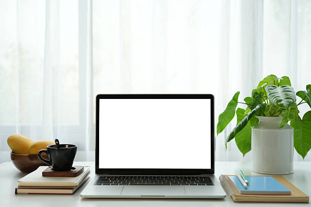istock Laptop white screen and drink and mango, cozy indoor work space 2210885554