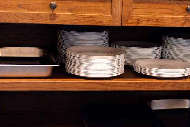 istock Neatly Stacked Plates on Wooden Kitchen Shelf 2210885828
