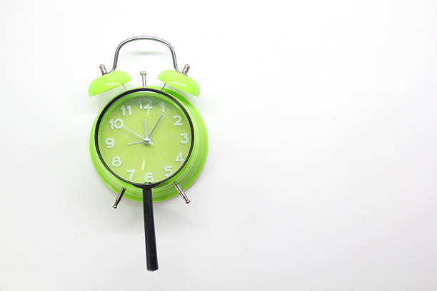 7 O'Clock wall clock above the wooden shelf on green concrete wall with copy space.