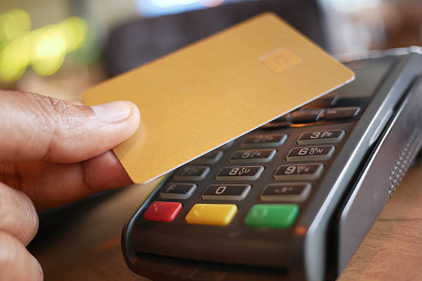 istock contactless payment concept with young man paying with credit card 2210887970