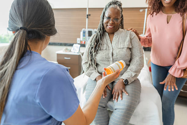 istock Nurse Explaining Medication to Patient with Family Present 2210890114