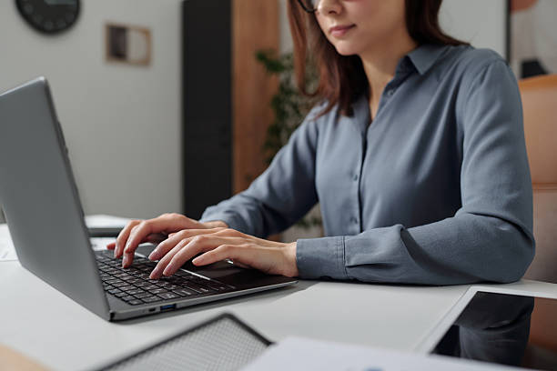 Successful Woman Typing on Keyboard in Office
