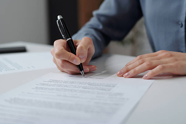 istock Woman Signing Contract in Office 2210892888
