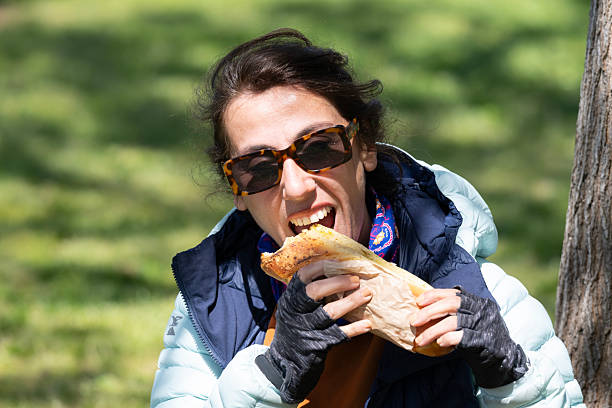 Woman eating a sandwich in a picnic