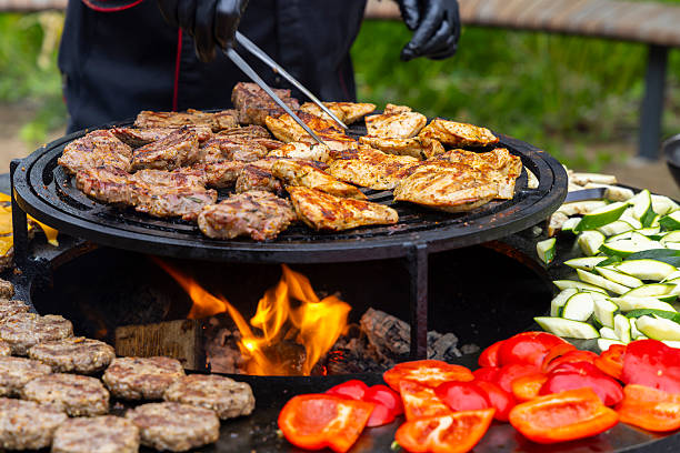 istock Chef grilling meat and vegetables on barbecue grill using tongs 2210895246