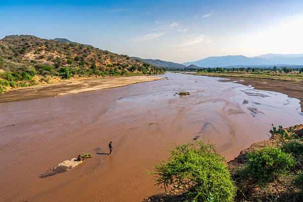 people taking a bath in the Turmi River