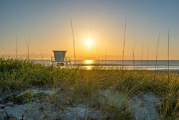 Lifeguard stand on the beach during a vibrant spring sunrise at Cocoa Beach in Central Florida USA