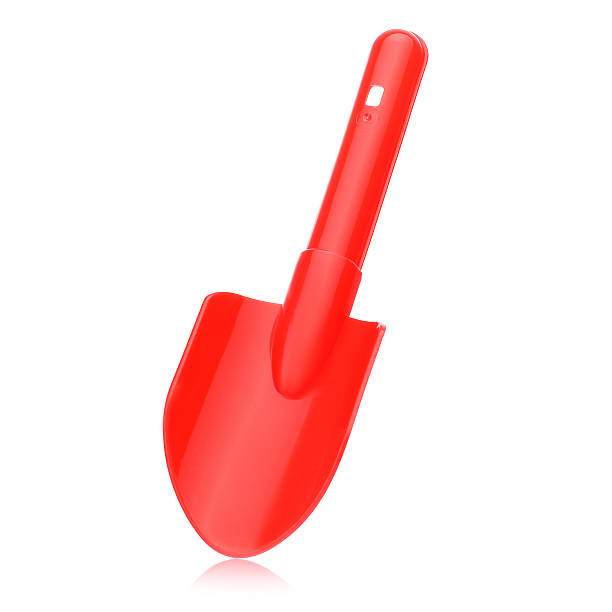 istock A plastic children's red shovel on a white background for playing with sand and earth. 2210901400