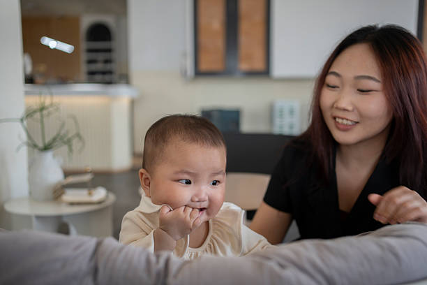 Happy interaction between Asian mother and her baby