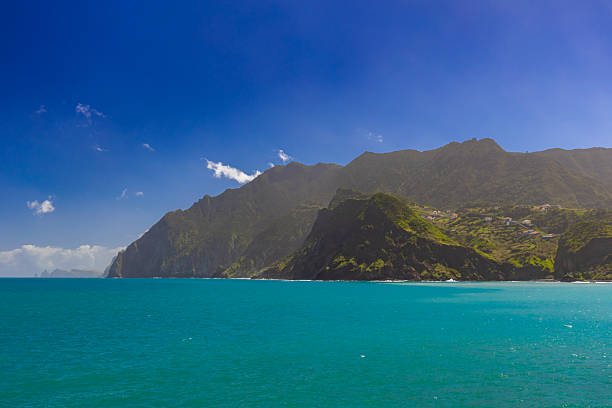 Landscape with coast and blue Atlantic Ocean with waves on a beautiful sunny day in Madeira (Porto da Cruz), background or wallpaper for your project