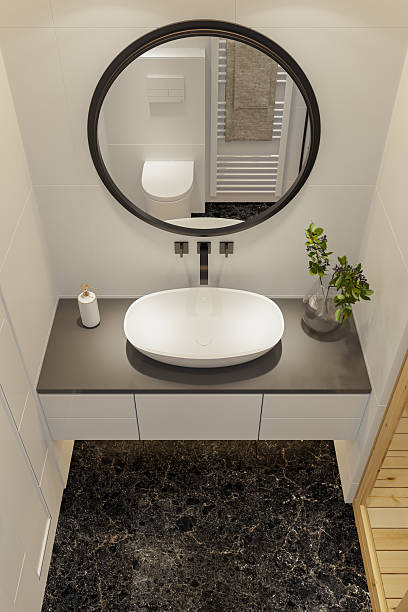 istock Modern Vanity Setup with Wall-Mounted Black Faucet and Round Mirror 2210907618