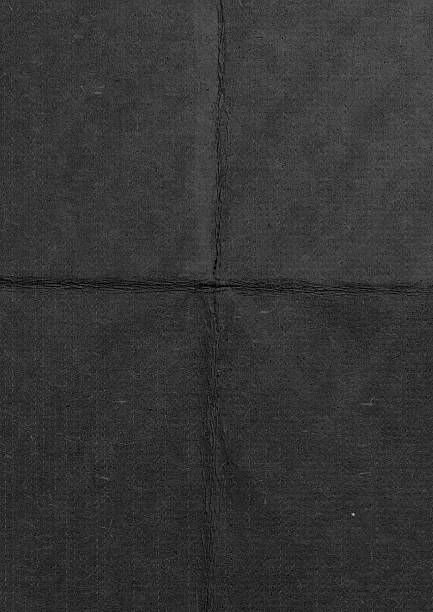 istock detailed textured image of dark folded paper with a natural rough surface. 2210915444